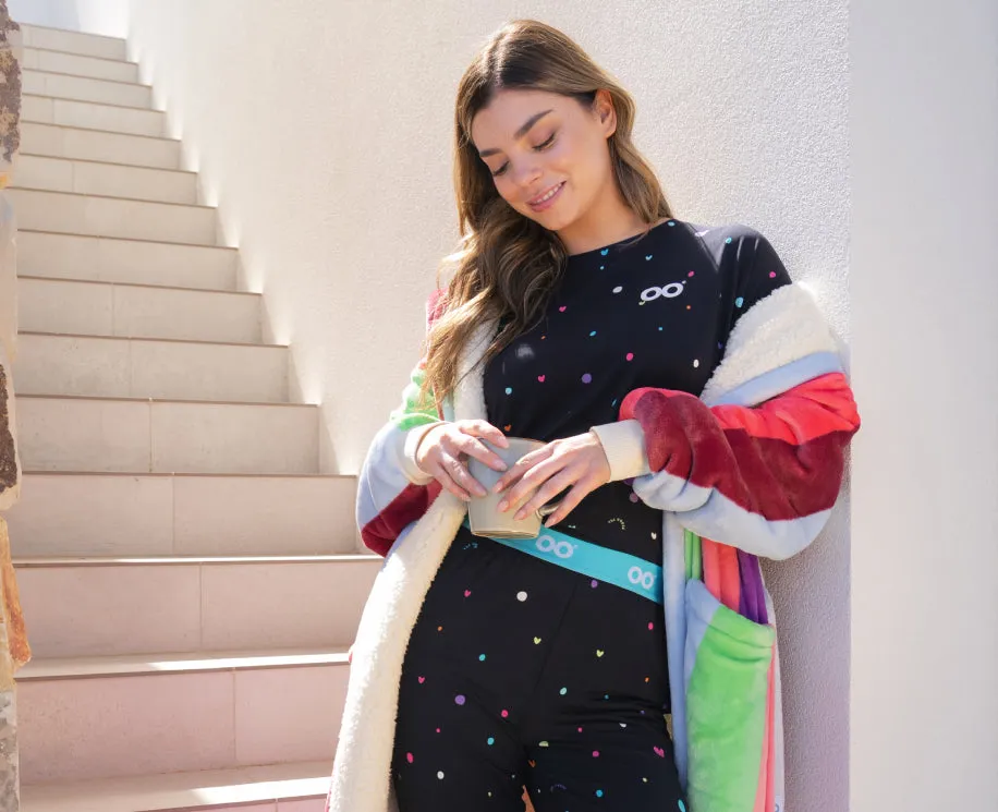 Woman on a staircase in black loungewear with a colour block robe